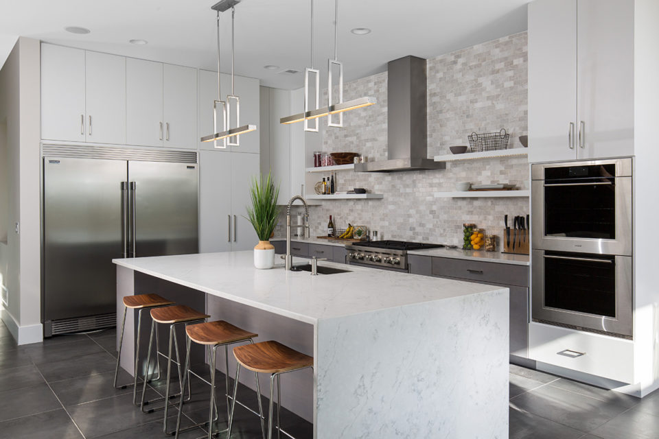 kitchen with large white quartz island with a waterfall edge