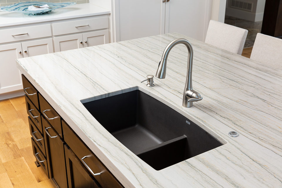 kitchen island with a black under mount sink