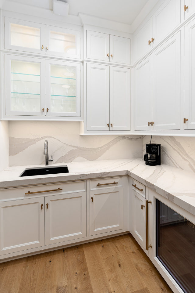 Pantry with quartz countertop and quartz backsplash